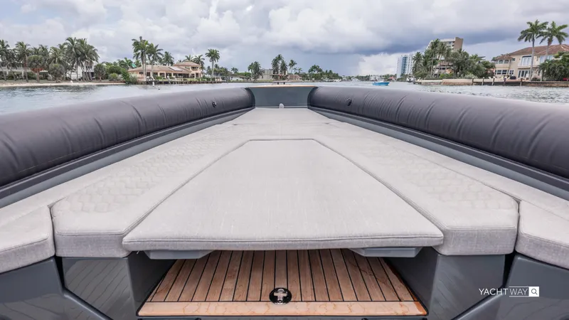 Slide: The Image of Luxurious 2025 Skipper-BSK 38NC yacht deck with cushioned seating, overlooking waterfront homes. - 19