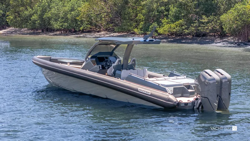 Slide: The Image of 2025 Skipper-BSK 38NC boat on calm water near lush greenery. - 9