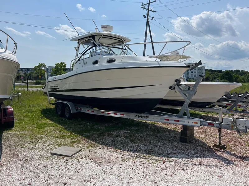 The Image of 2003 Hydra-Sports Vector 2800 WA boat on trailer, parked outdoors under a clear sky. - 0