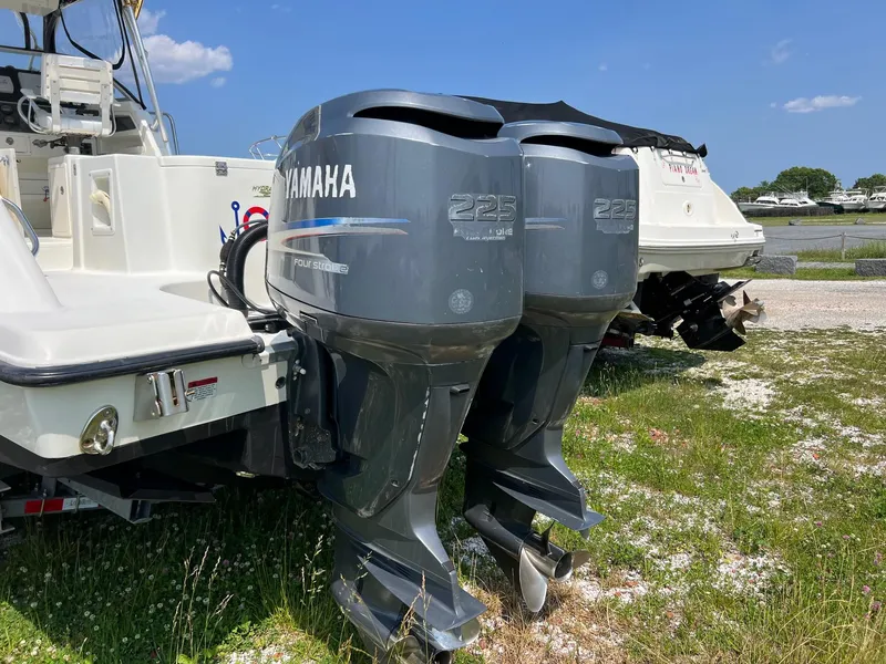 Slide: The Image of 2003 Hydra-Sports Vector 2800 WA with twin Yamaha 225 outboard engines, parked on grass. - 2