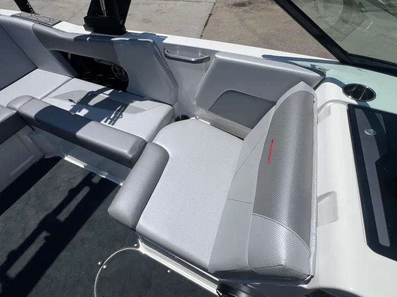 Slide: The Image of 2020 MasterCraft NXT20 boat interior with gray seating and cup holder. - 10
