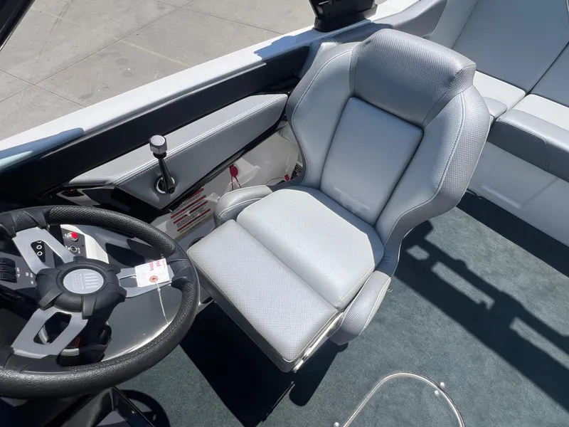Slide: The Image of 2020 MasterCraft NXT20 boat interior with steering wheel and captain's seat. - 11