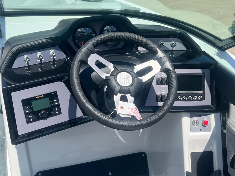 Slide: The Image of Steering console of 2020 MasterCraft NXT20 boat with modern controls and Klipsch audio system. - 12