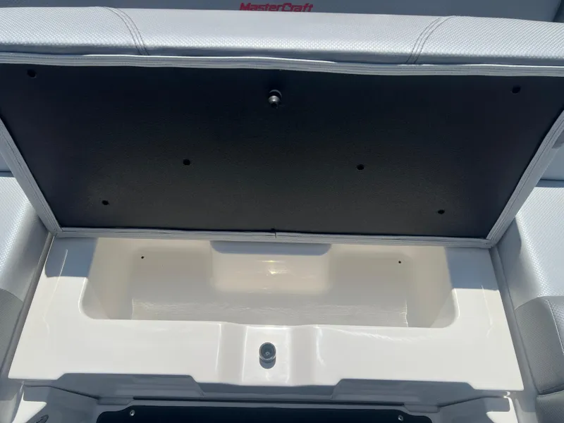 Slide: The Image of Open storage compartment in 2020 MasterCraft NXT20 boat interior. - 16