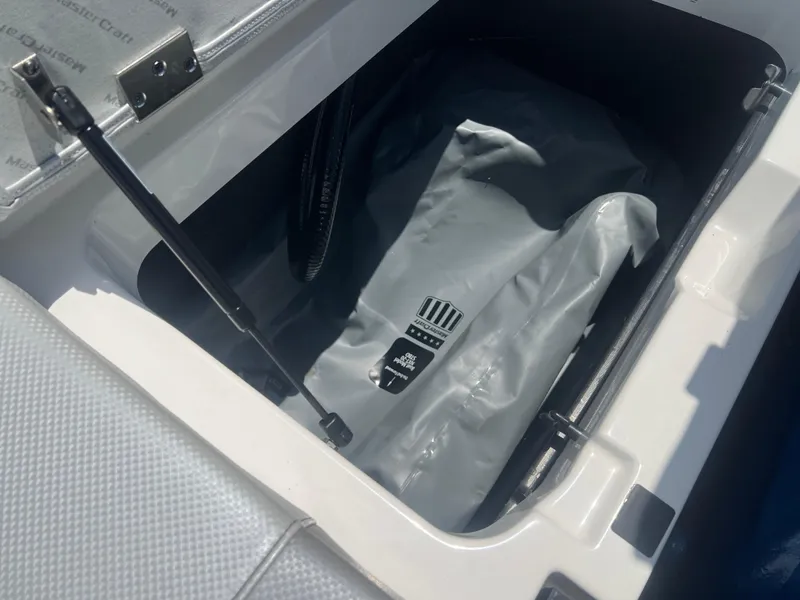 Slide: The Image of 2020 MasterCraft NXT20 boat storage compartment with hydraulic lift and protective cover. - 18