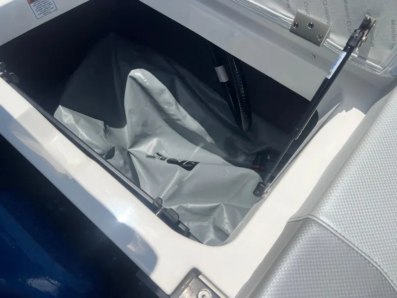 Slide: The Image of Storage compartment of a 2020 MasterCraft NXT20 boat with cover inside. - 19