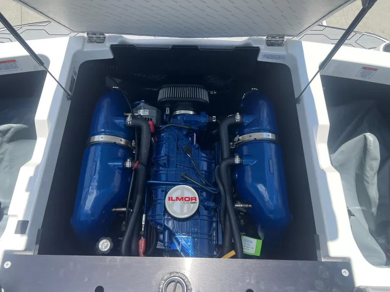 Slide: The Image of 2020 MasterCraft NXT20 boat engine compartment with Ilmor engine, blue components visible. - 20
