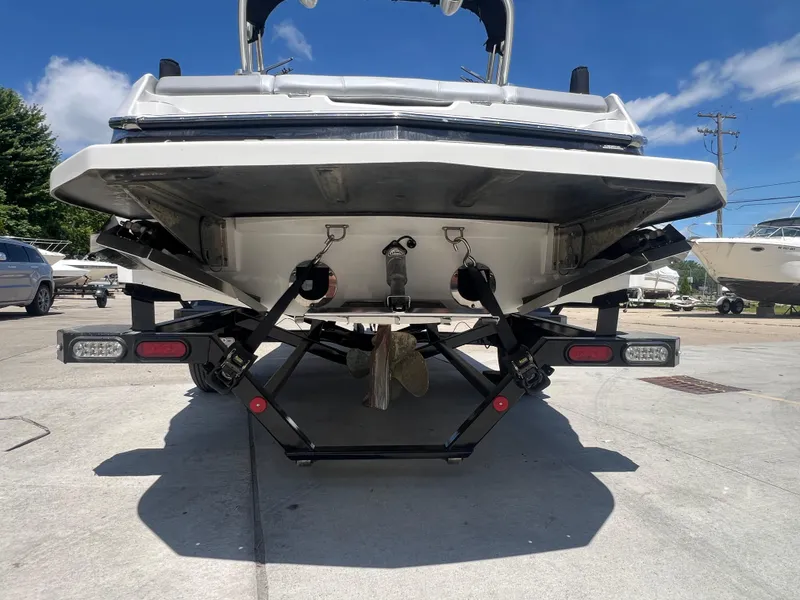 Slide: The Image of 2020 MasterCraft NXT20 boat on trailer, rear view, sunny day, marina background. - 5