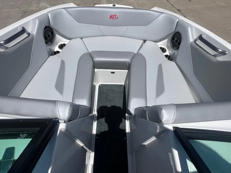 Slide: The Image of 2020 MasterCraft NXT20 boat interior with gray seating and cup holders. - 8