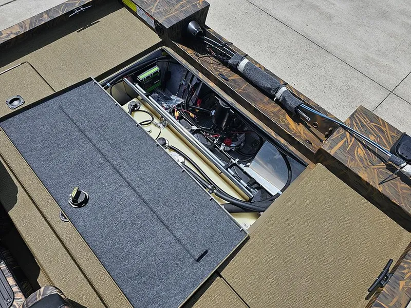 Slide: The Image of 2026 G3 Sportsman 1710 boat interior showing storage compartments and fishing rod holders. - 10