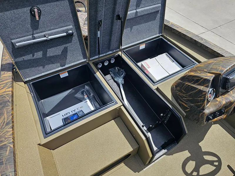 Slide: The Image of 2026 G3 Sportsman 1710 boat storage compartments with electronics and accessories. - 18