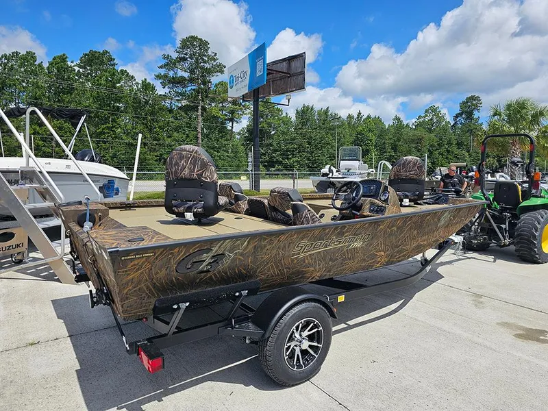 Slide: The Image of 2026 G3 Sportsman 1710 boat with camouflage design on a trailer, parked outdoors. - 6