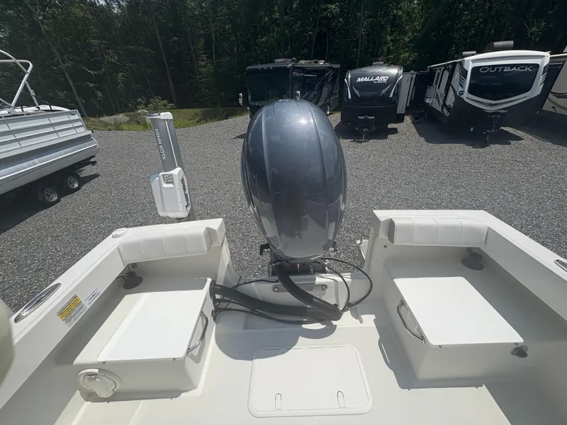 Slide: The Image of 2021 Parker 2300 Special Edition boat with outboard motor, parked near RVs. - 14
