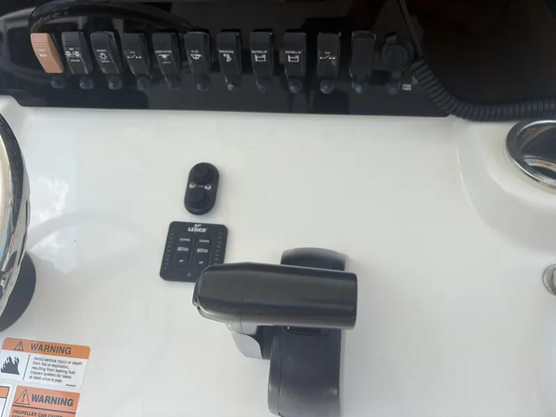 Slide: The Image of Control panel of a 2021 Parker 2300 Special Edition boat with switches and throttle. - 16
