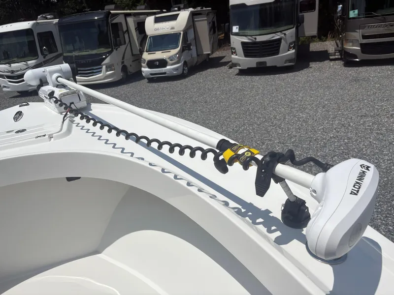 Slide: The Image of 2021 Parker 2300 Special Edition boat with Minn Kota trolling motor, parked near RVs. - 24