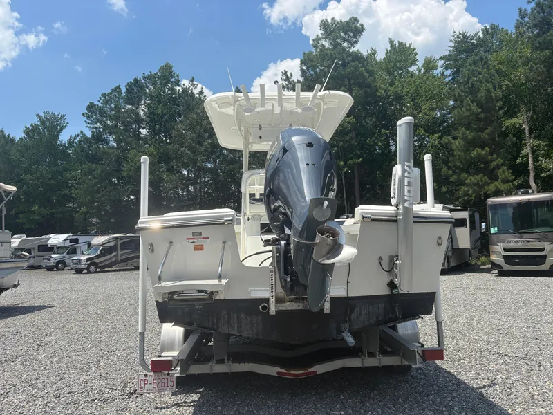 Slide: The Image of 2021 Parker 2300 Special Edition boat with outboard motor in a parking lot. - 4