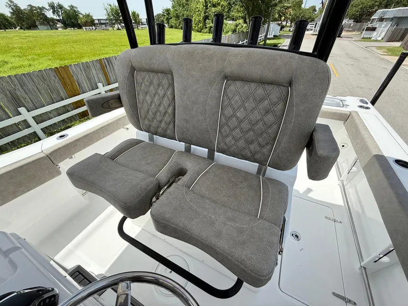 Slide: The Image of 2026 Sea Hunt Gamefish 28 Coffin Box boat with cushioned seating and rod holders. - 10