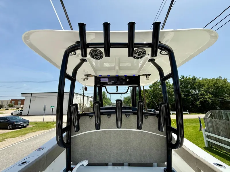 Slide: The Image of 2026 Sea Hunt Gamefish 28 Coffin Box boat with rod holders and speakers, viewed from the rear. - 13