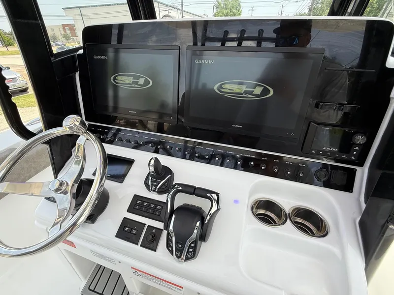 Slide: The Image of 2026 Sea Hunt Gamefish 28 Coffin Box dashboard with dual Garmin displays and controls. - 19