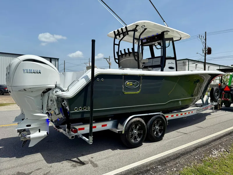 Slide: The Image of 2026 Sea Hunt Gamefish 28 Coffin Box boat on trailer, featuring Yamaha engines. - 4