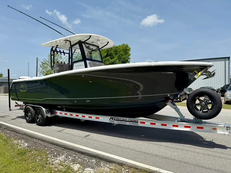 Slide: The Image of 2026 Sea Hunt Gamefish 28 Coffin Box boat on trailer, parked outdoors. - 5