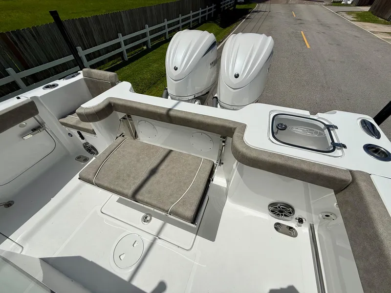Slide: The Image of 2026 Sea Hunt Gamefish 28 Coffin Box boat interior with dual engines and seating. - 7