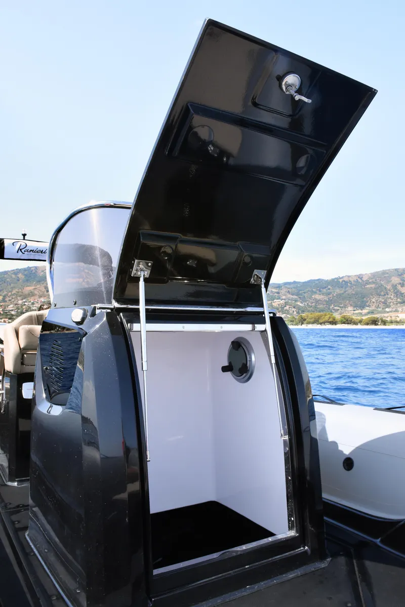 Slide: The Image of 2023 Ranieri CAYMAN 26 SPORT TOURING boat with open storage compartment. - 24