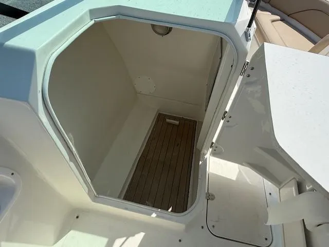 Slide: The Image of 2020 NauticStar 2302 Legacy Dual Console boat interior storage compartment. - 11