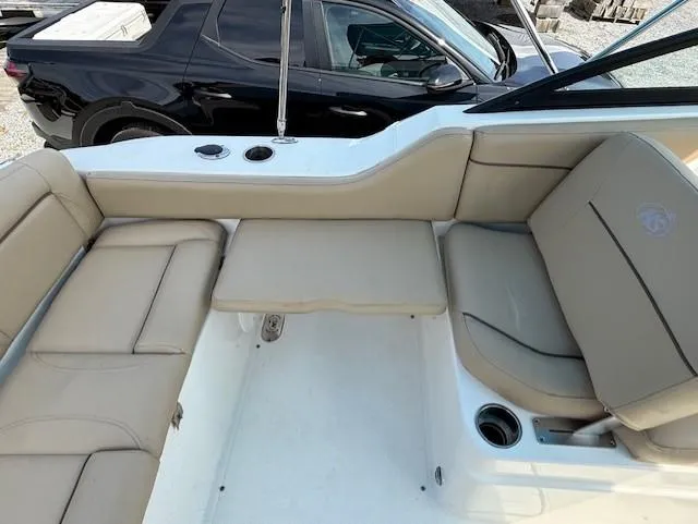 Slide: The Image of 2020 NauticStar 2302 Legacy Dual Console boat interior with beige seating. - 12