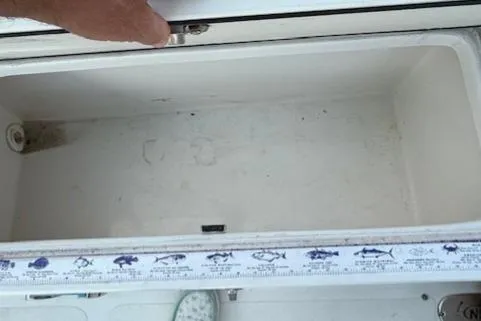 Slide: The Image of Open storage compartment on 2020 NauticStar 2302 Legacy Dual Console boat. - 20