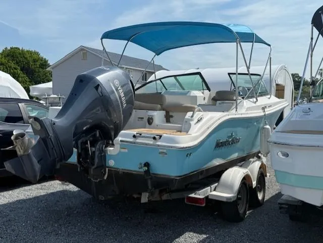 Slide: The Image of 2020 NauticStar 2302 Legacy Dual Console boat with Yamaha outboard engine on trailer. - 4