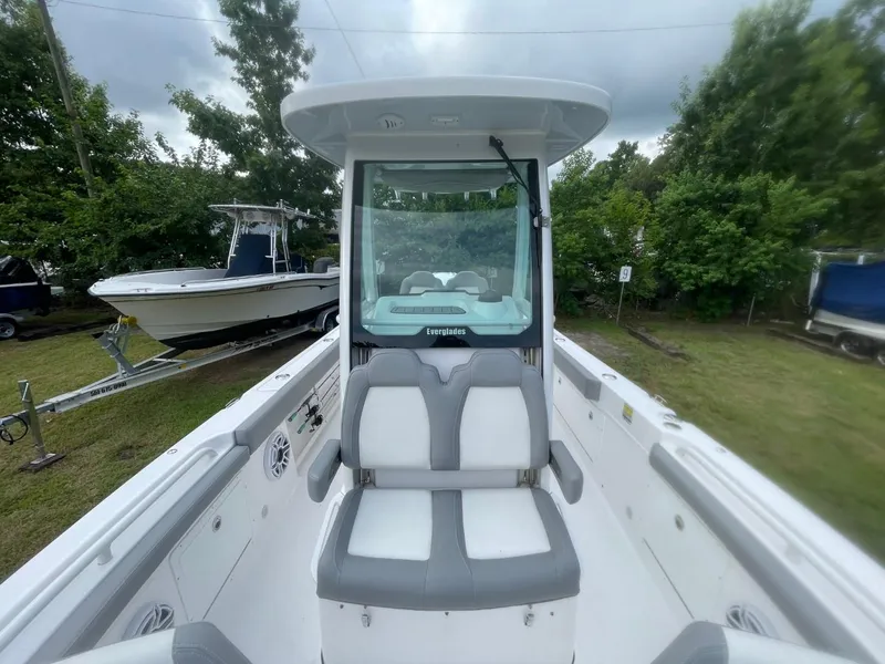 Slide: The Image of 2023 Everglades 235 Center Console boat with dual seating, parked outdoors. - 11