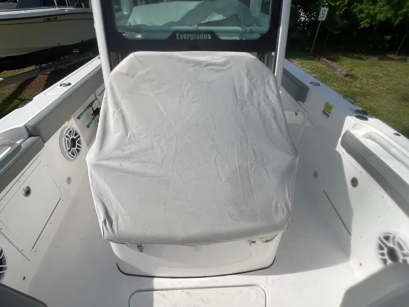Slide: The Image of 2023 Everglades 235 Center Console boat interior with covered seating and speakers. - 12
