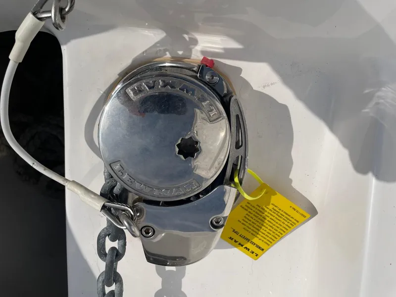 Slide: The Image of 2023 Everglades 235 Center Console boat anchor winch with chain and safety tag. - 15