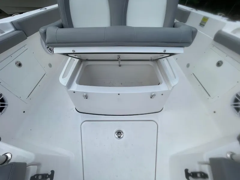 Slide: The Image of 2023 Everglades 235 Center Console boat with open storage compartment and cushioned seating. - 16