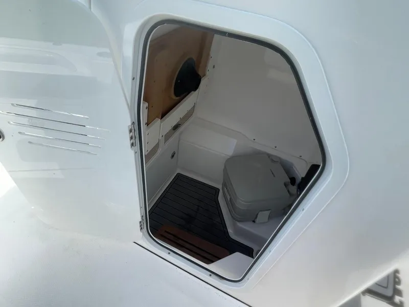 Slide: The Image of Interior view of 2023 Everglades 235 Center Console boat's compact cabin space. - 18