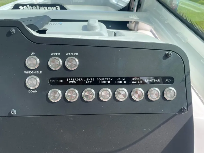 Slide: The Image of Control panel of 2023 Everglades 235 Center Console boat with various function buttons. - 25