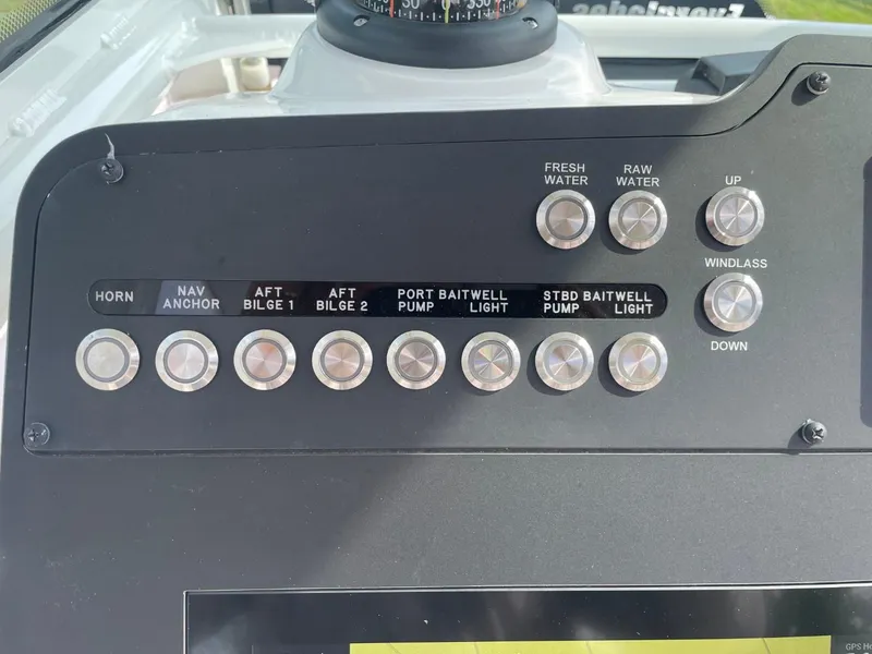 Slide: The Image of Control panel of 2023 Everglades 235 Center Console boat with various function buttons. - 26