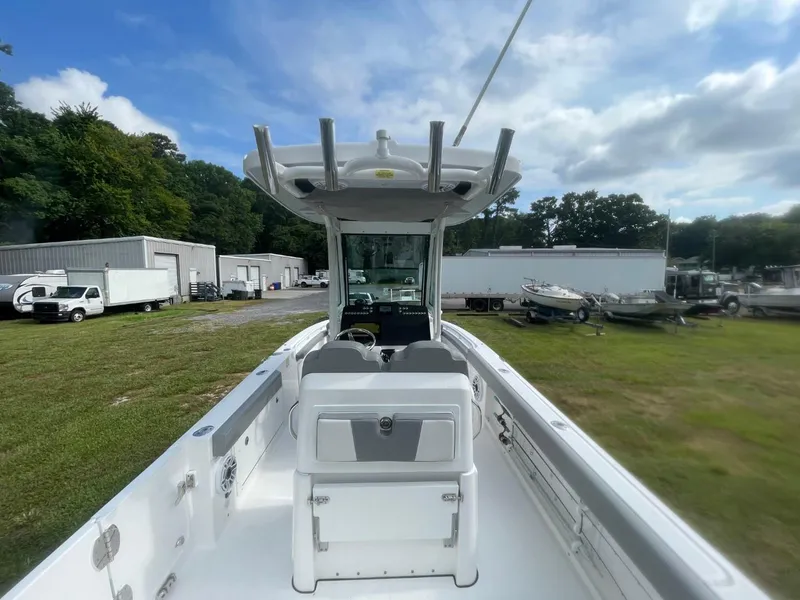 Slide: The Image of 2023 Everglades 235 Center Console boat in a storage yard, showcasing sleek design and spacious deck. - 28
