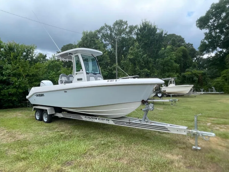 Slide: The Image of 2023 Everglades 235 Center Console boat on trailer, parked on grass. - 3