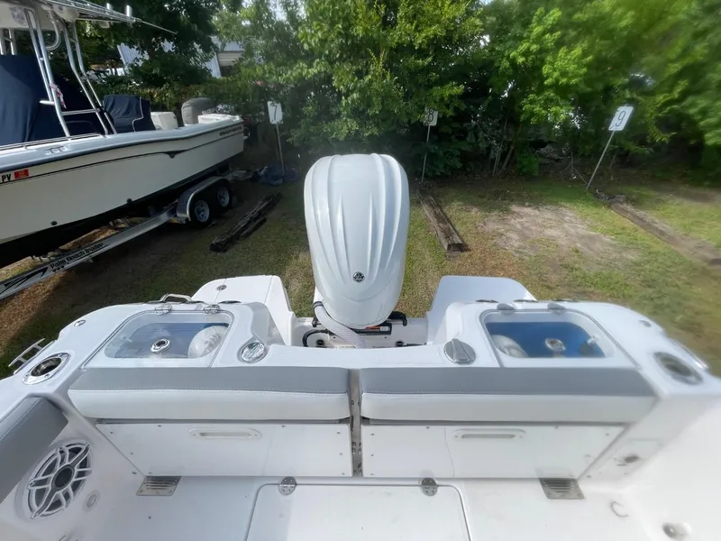 Slide: The Image of 2023 Everglades 235 Center Console boat with outboard motor, parked on grass. - 32