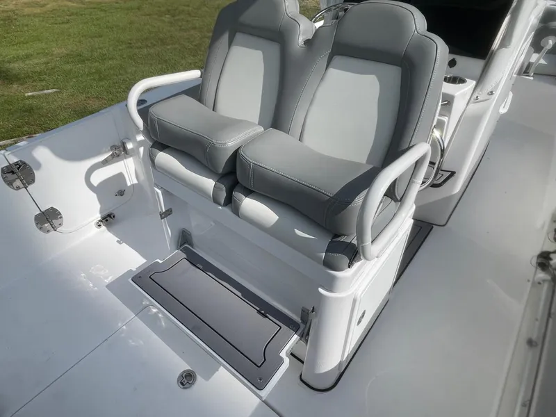 Slide: The Image of 2023 Everglades 235 Center Console boat seats with armrests, featuring sleek gray upholstery. - 33