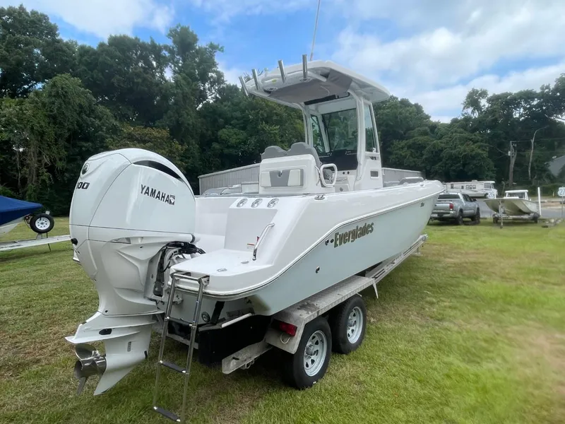 Slide: The Image of 2023 Everglades 235 Center Console boat with Yamaha engine on trailer, parked on grass. - 4
