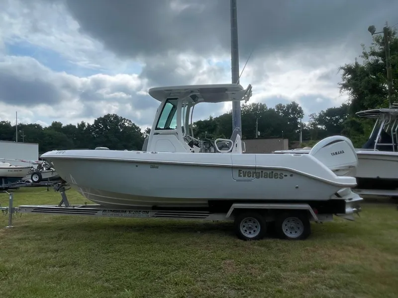 Slide: The Image of 2023 Everglades 235 Center Console boat on trailer, parked outdoors under cloudy sky. - 7