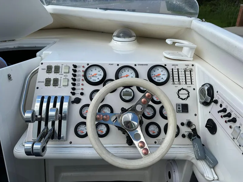 Slide: The Image of 1994 Fountain 35 Lightning boat dashboard with gauges, controls, and steering wheel. - 14