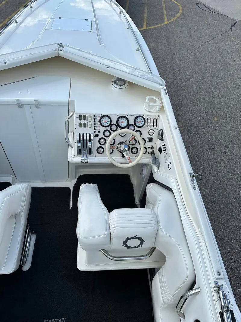 Slide: The Image of 1994 Fountain 35 Lightning boat cockpit with white seats and detailed control panel. - 15