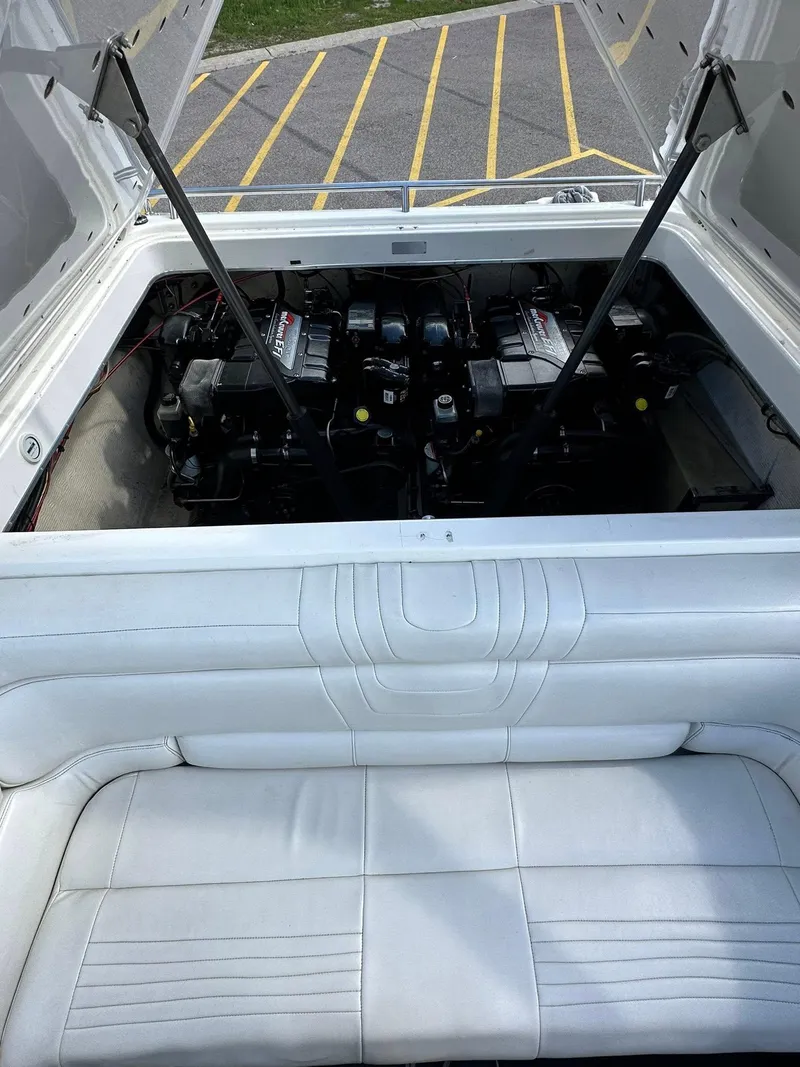 Slide: The Image of 1994 Fountain 35 Lightning boat engine compartment with white upholstery and dual engines. - 17