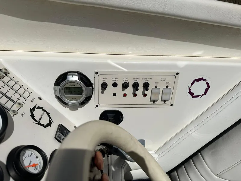 Slide: The Image of 1994 Fountain 35 Lightning boat dashboard with controls and gauges. - 18