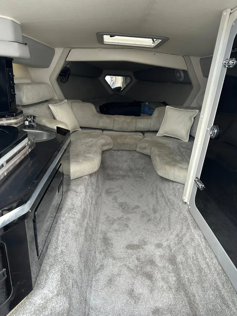 Slide: The Image of Interior of a 1994 Fountain 35 Lightning boat with plush seating and compact kitchenette. - 20