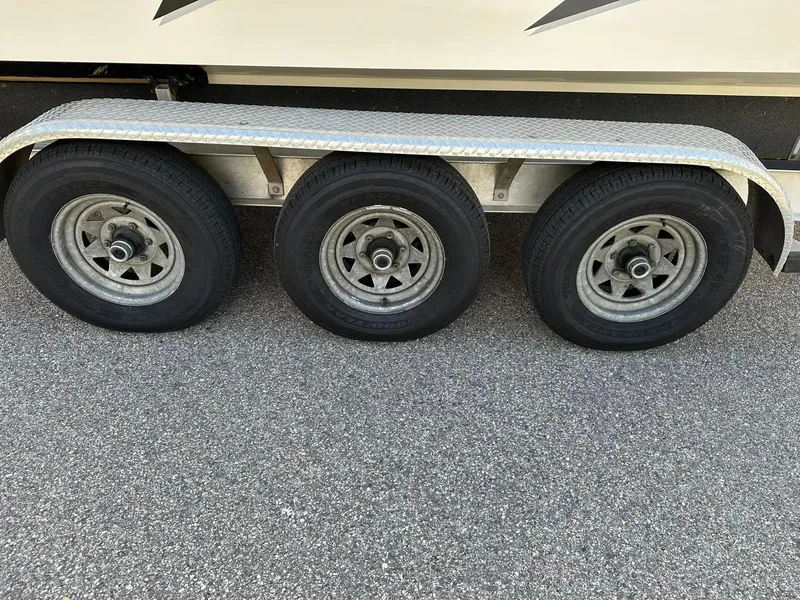 Slide: The Image of Triple axle trailer for 1994 Fountain 35 Lightning boat on asphalt. - 30